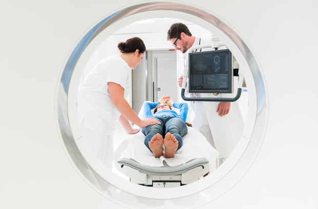 Radiologist and a nurse with a patient in a CT scanner